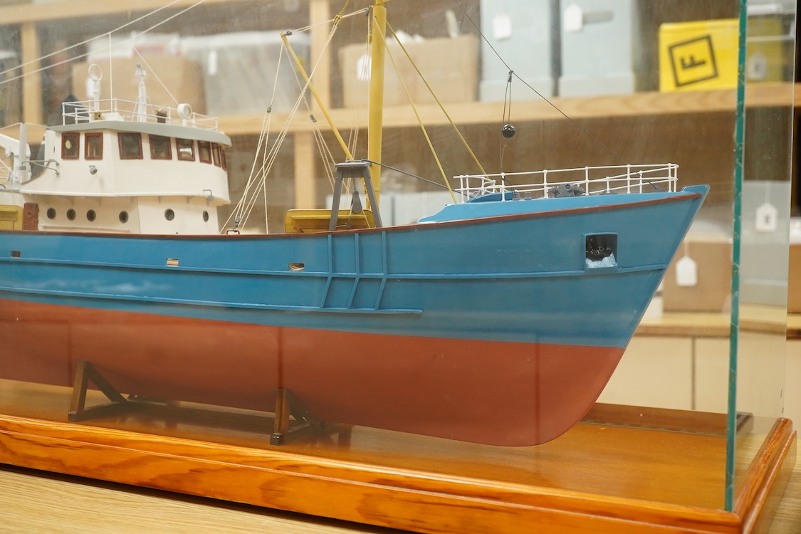 A model of a fishing trawler ship constructed from a kit by Billings Boats models, of painted wood construction, finished to a high standard with a good level of detail, presented in a glazed cabinet on a wooden base, ca